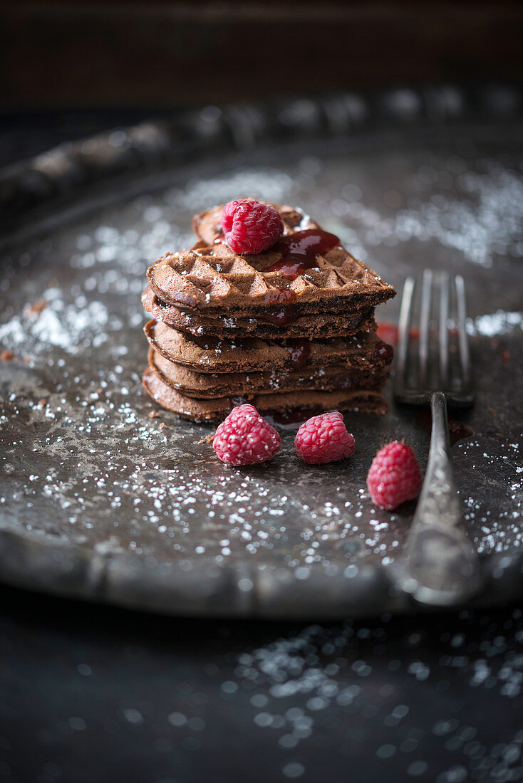Chocolate waffle hearts with raspberry and chocolate sauce and fresh fruits (vegan)