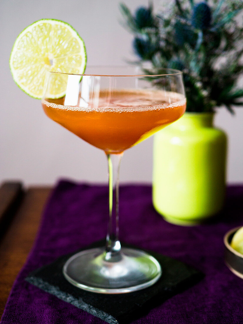Elegant Lions Tail cocktail with lime garnish