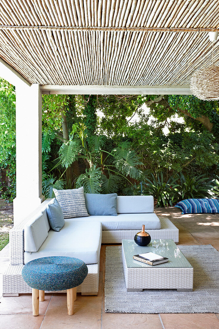 Couch and coffee table on roofed terrace