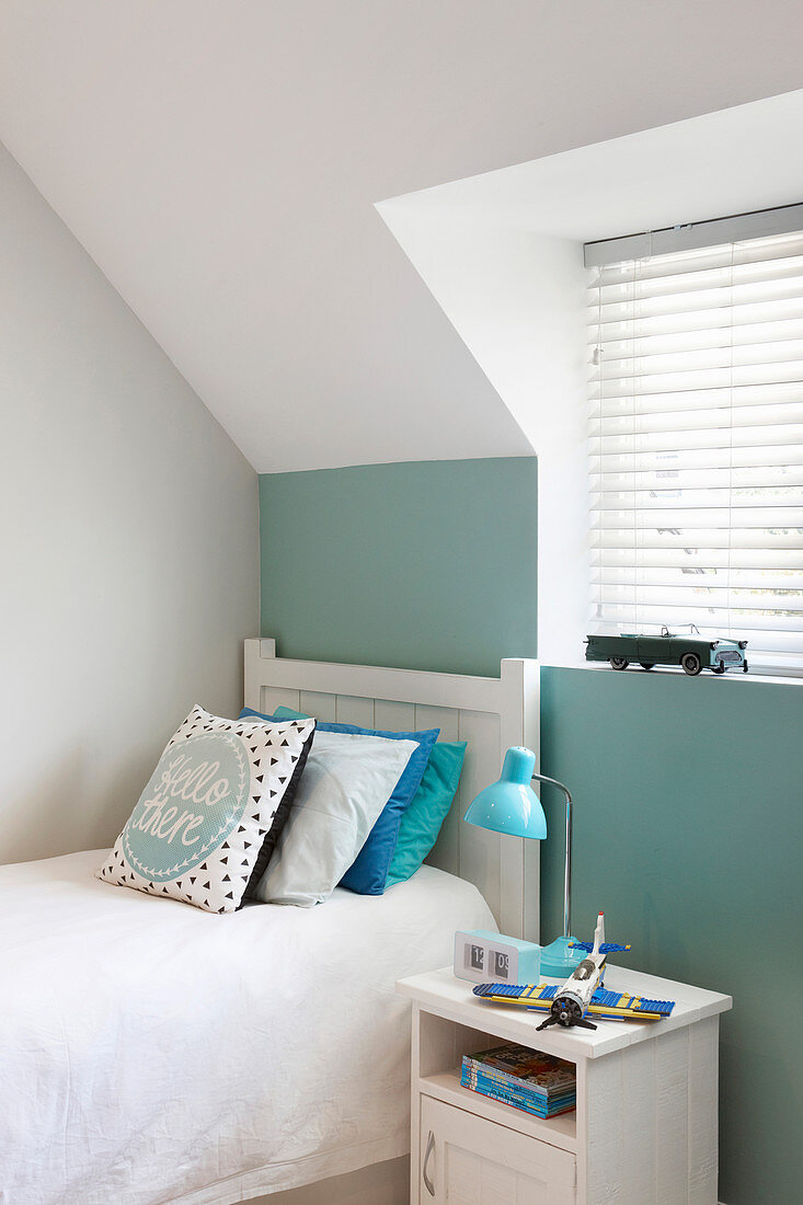 White and pale green walls in child's attic bedroom