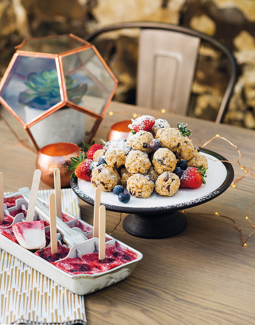 Muesli balls with chocolate and cranberries, with coconut-berry popsicles