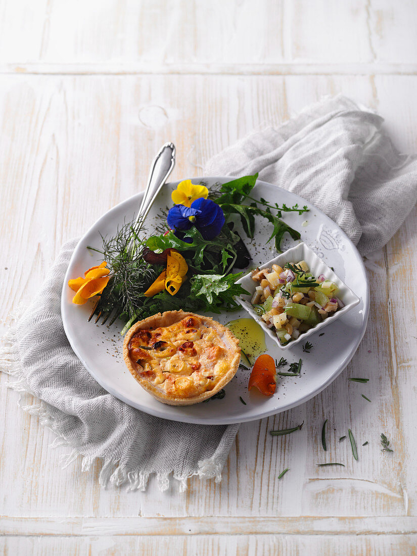 A mini vegetable quiche with a colourful salad