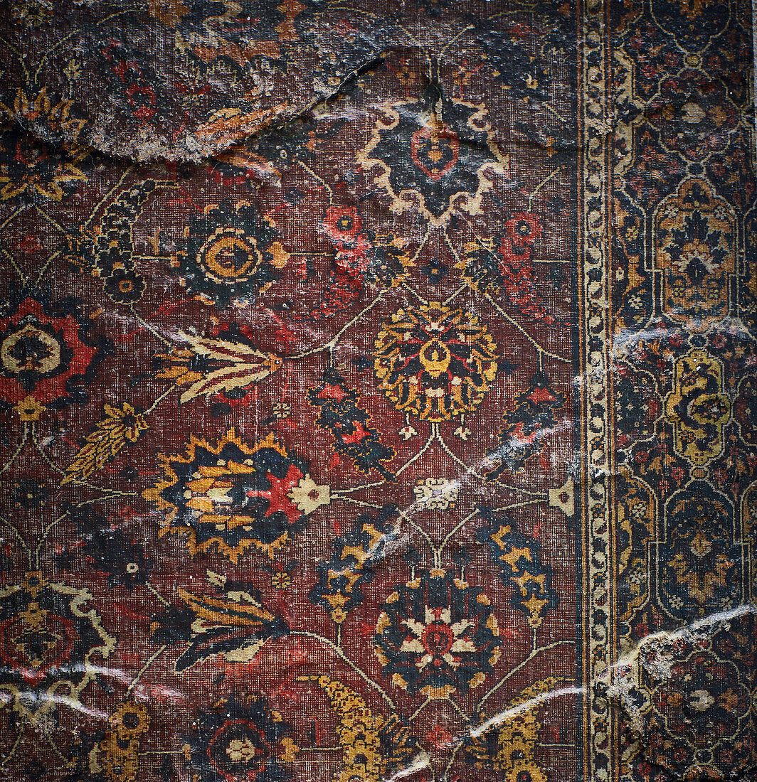 A dark patterned oriental rug