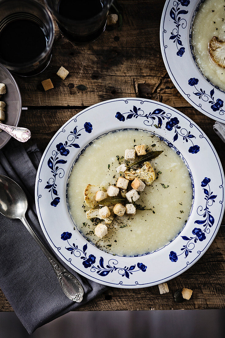 Cauliflower cream soup on a wooden dining table