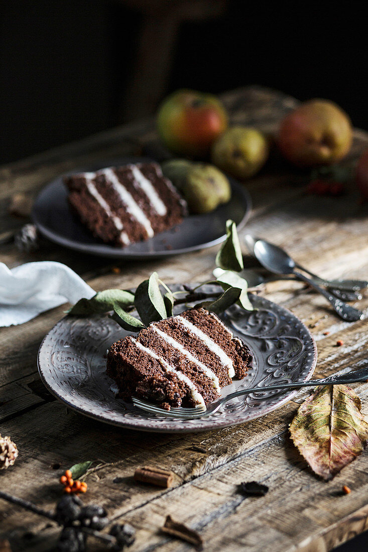 Slices of chocolate and pear cake on wooden table
