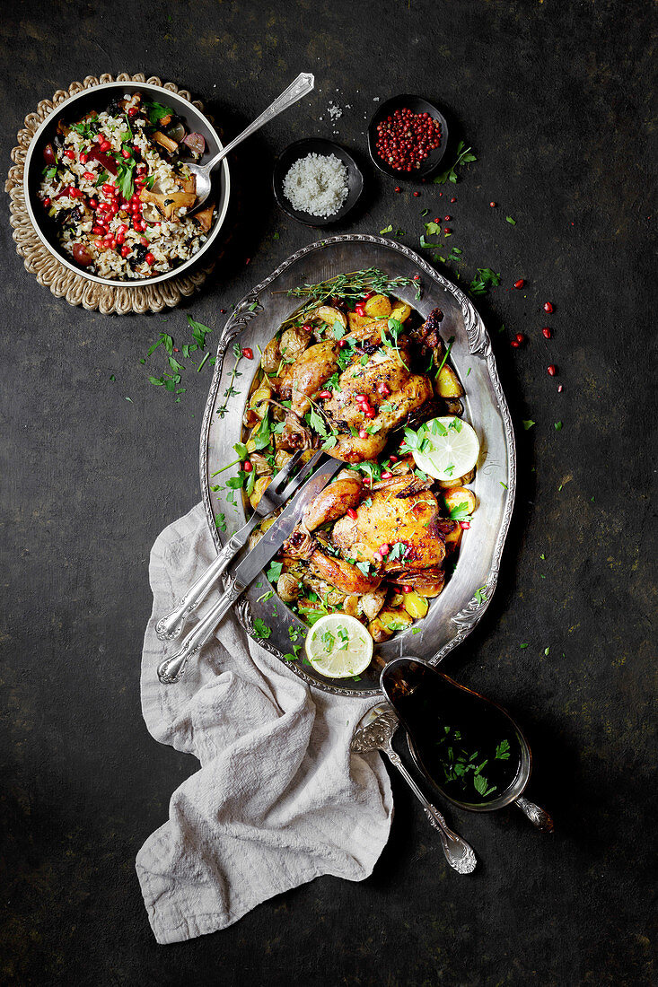 Fried chicken with herbs and pomegranate seeds, served with a side of rice