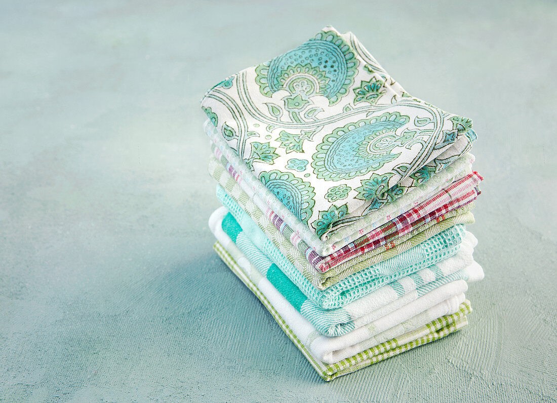 A stack of ironed and folded tea towels