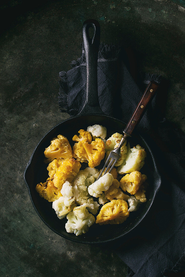 Iron cast pan of white and yellow cauliflower gratin