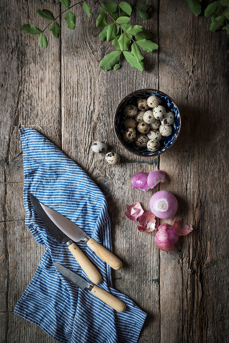 Quails eggs in a blue bowl in a rustic kitchen