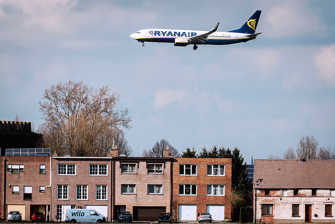 Passenger airliner flying over buildings