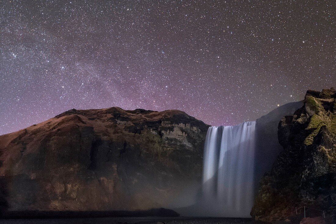 Night sky over Skogafoss waterfall, Iceland