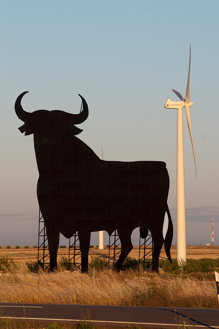 Bull advertising sign and wind turbine