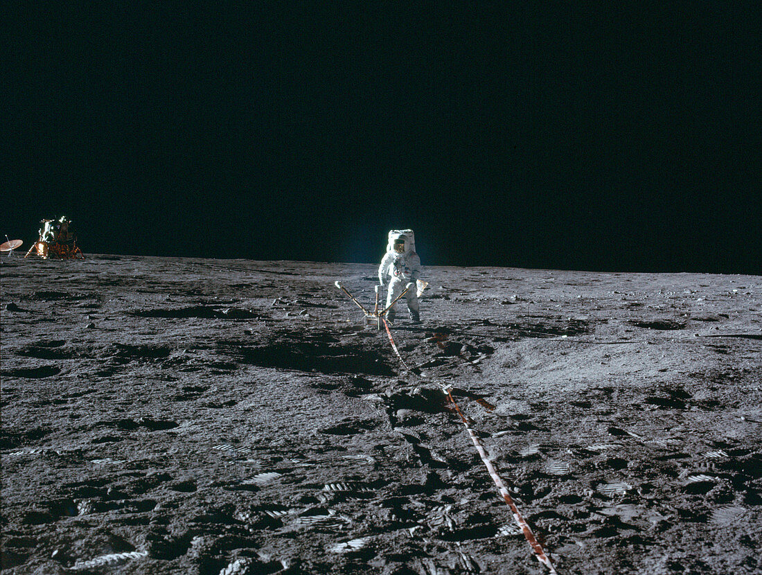 Apollo 12 astronaut setting up lunar experiment