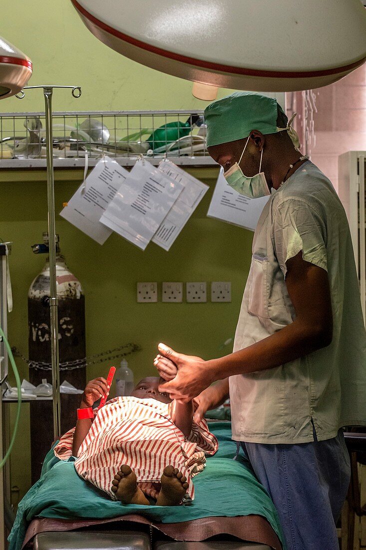 Surgeon with child awaiting surgery