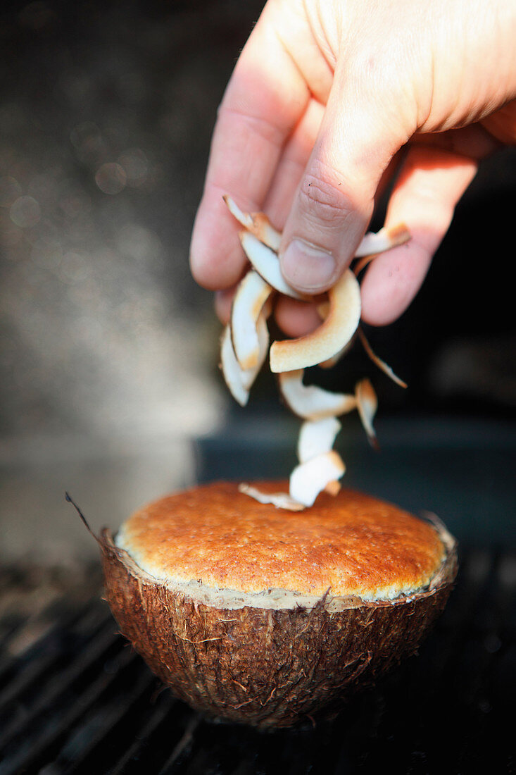 Grilled souffle with coconut flacks served in a coconut shell