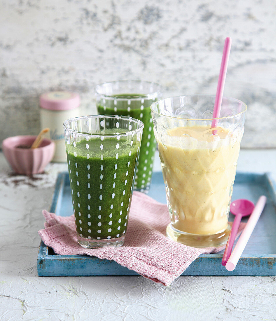 Green spinach and apricot smoothie, and a mango drink yoghurt