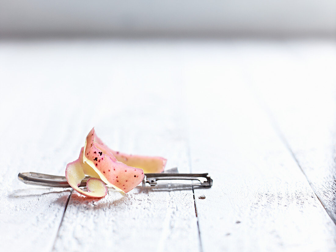 Potato peelings and a peeler