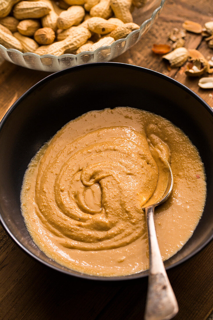 Homemade peanut butter in a bowl with a spoon