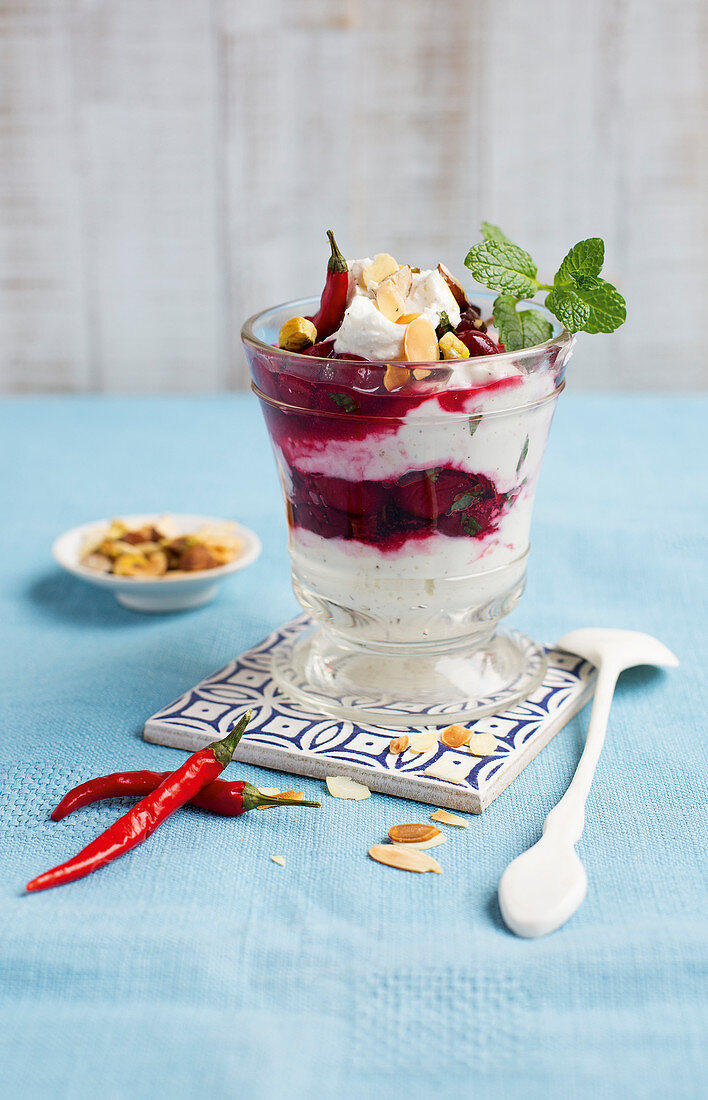 A cherry and vanilla layered dessert with nuts