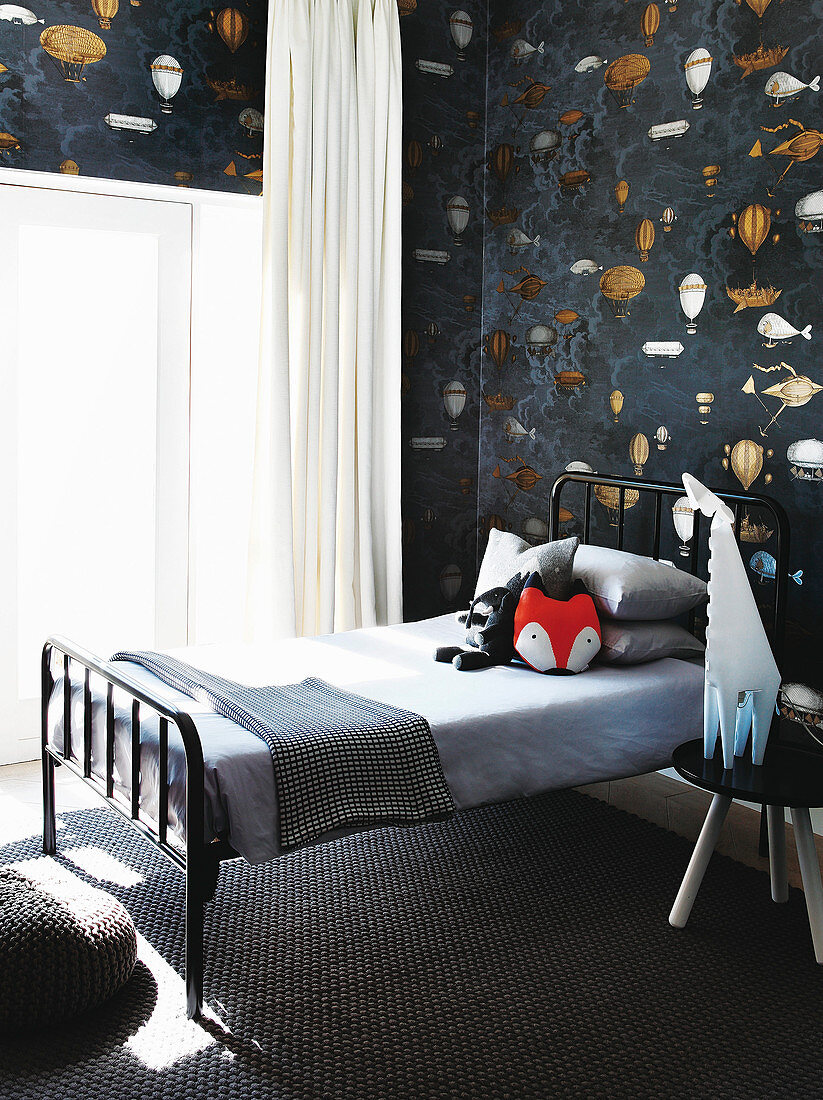 Metal bed in monochrome boy's bedroom