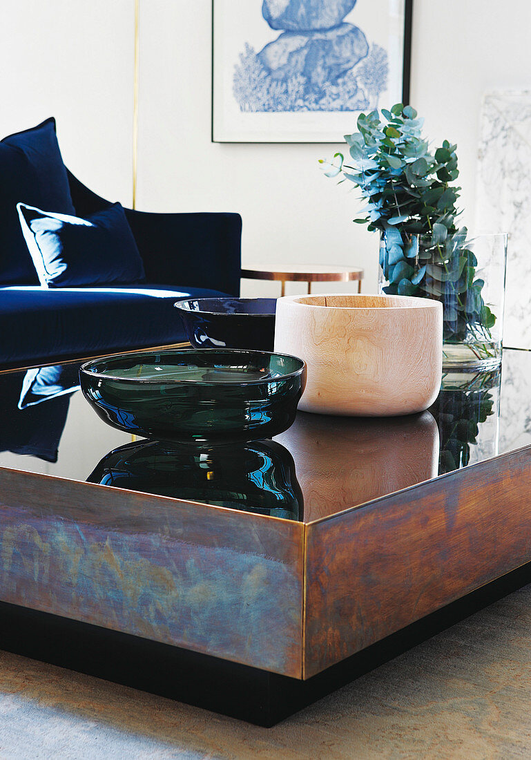 Bowls on chunky metal and glass coffee table