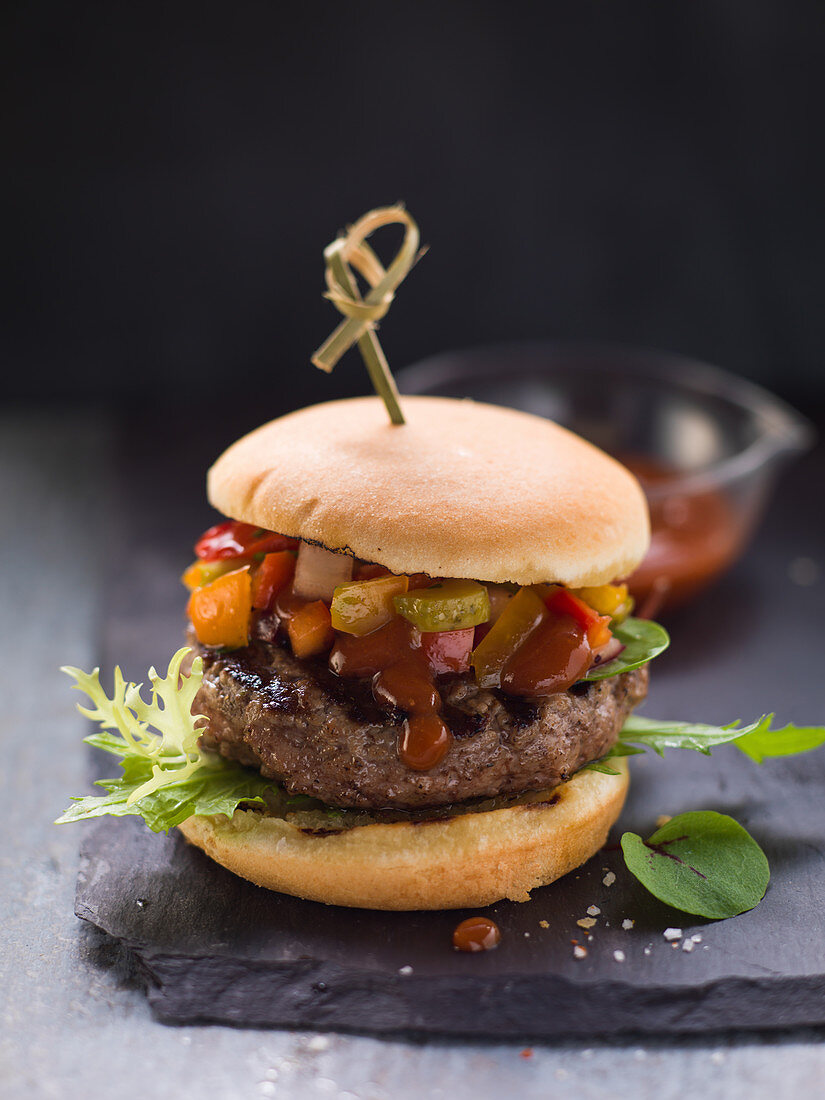 A classic beef burger with BBQ sauce and salad