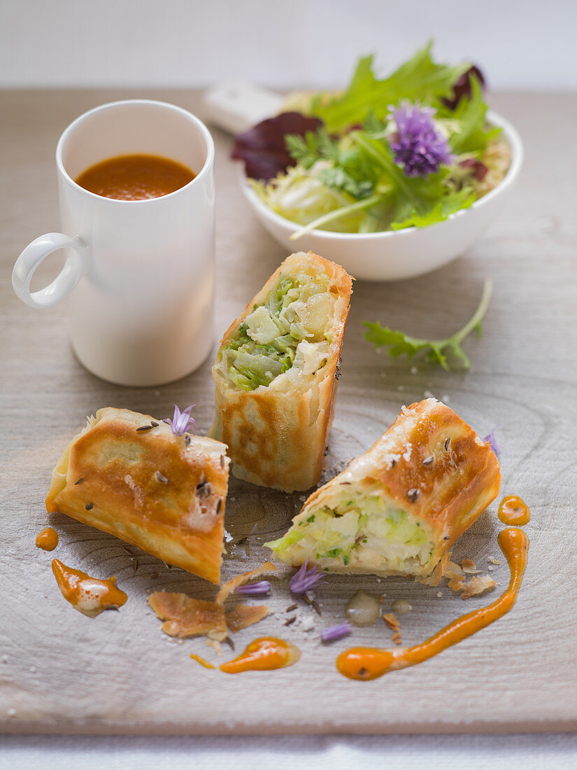 Herb strudel with pumpkin and pepper sauce