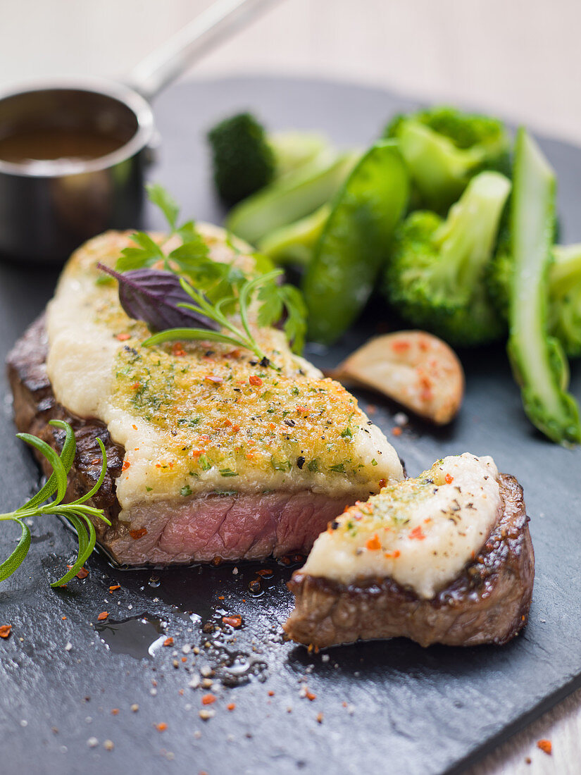 Roast beef with gratin celery puree on green vegetables
