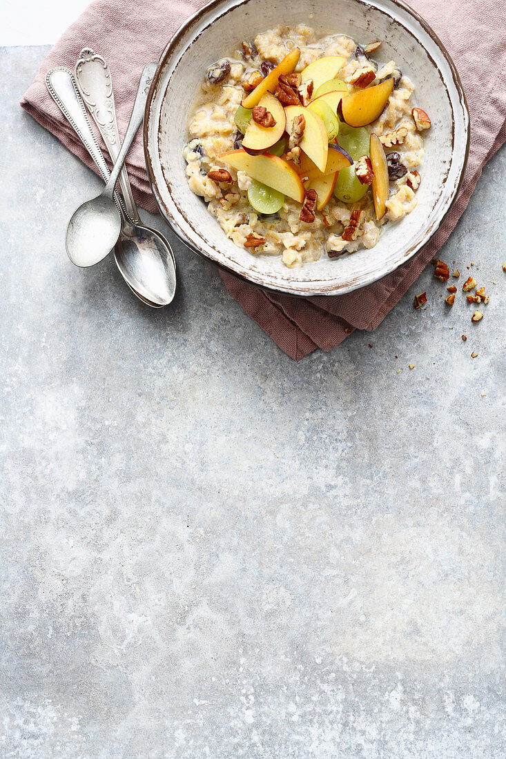 Autumnal porridge with apples, grapes and nuts