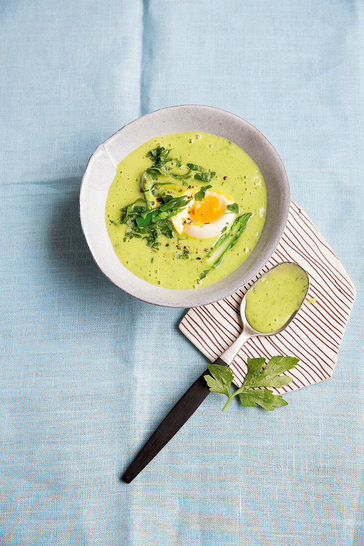 Cream of herb and asparagus soup with soft-boiled eggs