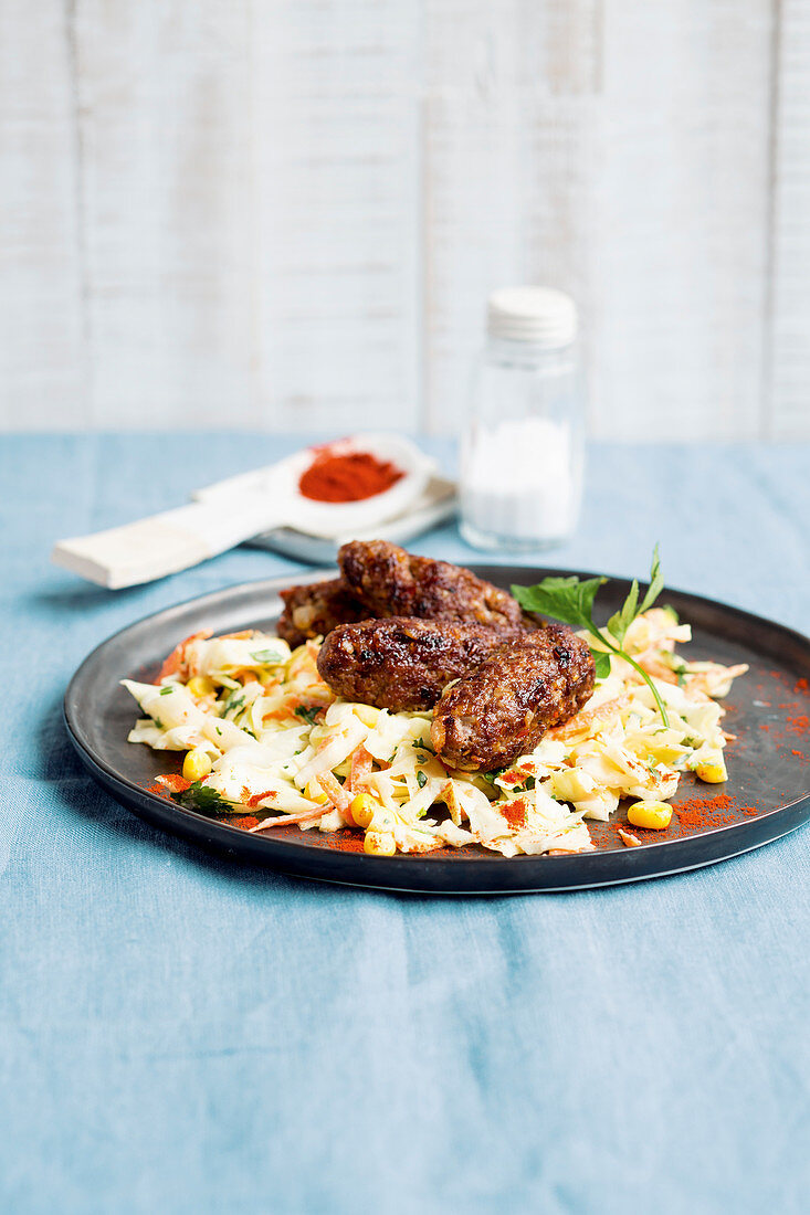 Pointed cabbage and sweetcorn salad with cevapcici