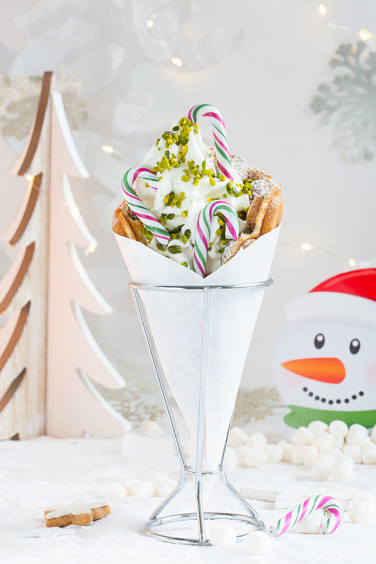 A bubble waffle with frozen yoghurt and candy canes for Christmas