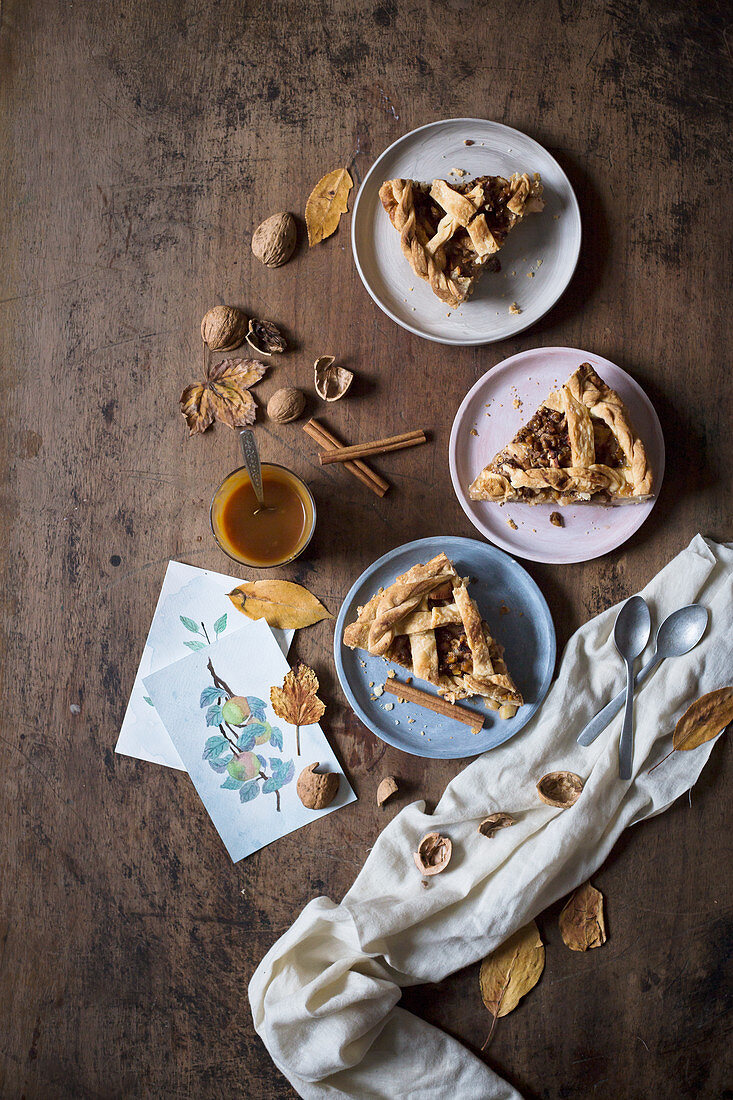 Slices of a rustic apple pie with walnuts and caramel sauce (seen from above)