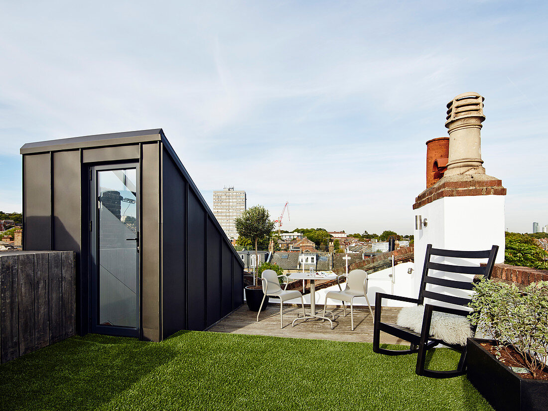 Artificial lawn on roof terrace with city view