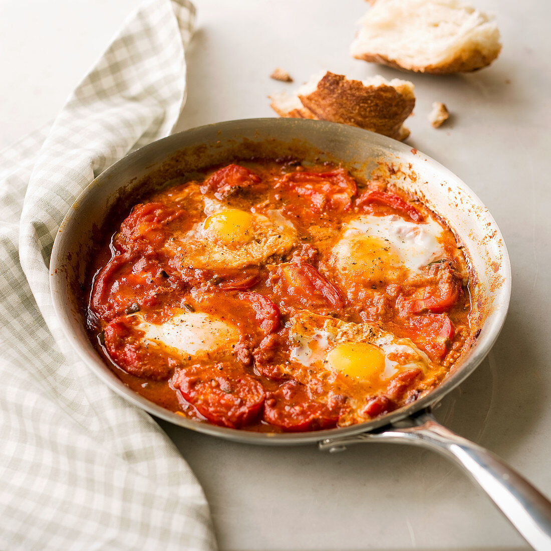 Paprika Tomatoes with Poached Eggs in a skillet