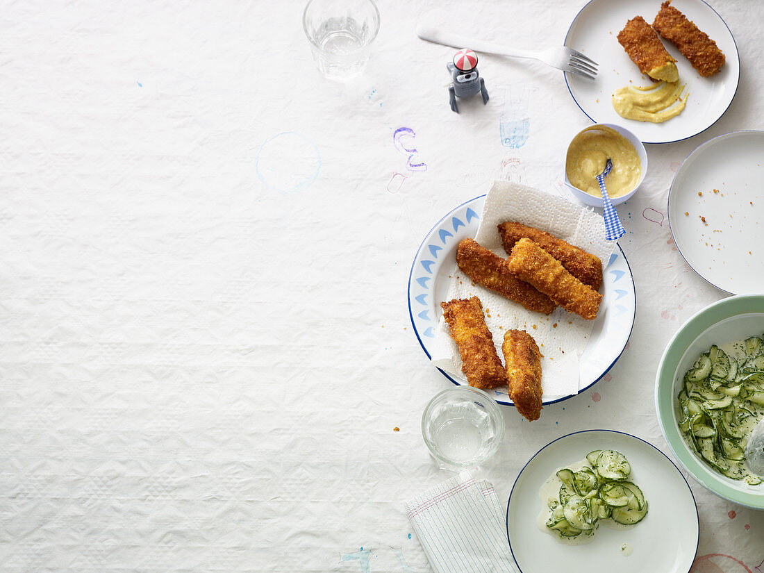Fish fingers with a cornflake coating served with Joppie sauce and cucumber salad