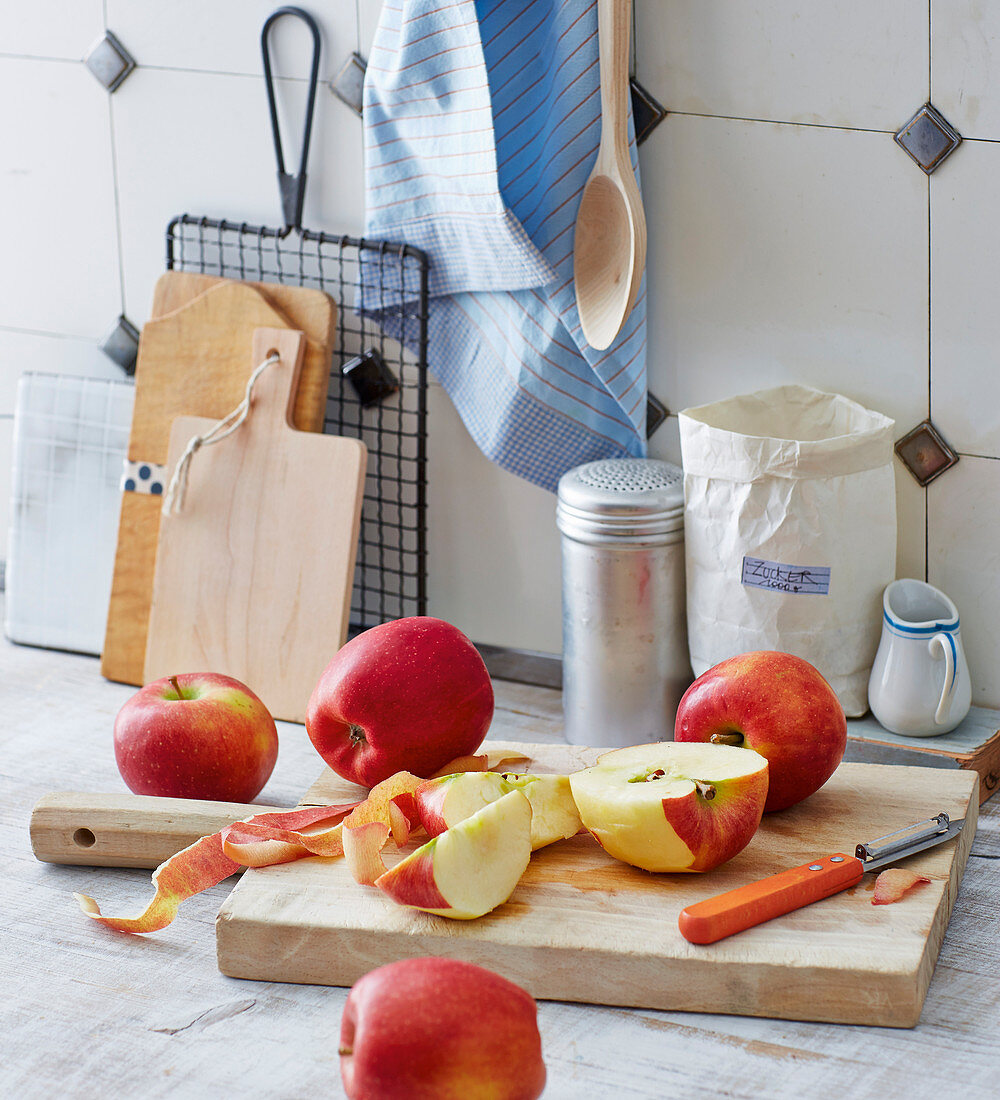 A kitchen scene – red apples being sliced