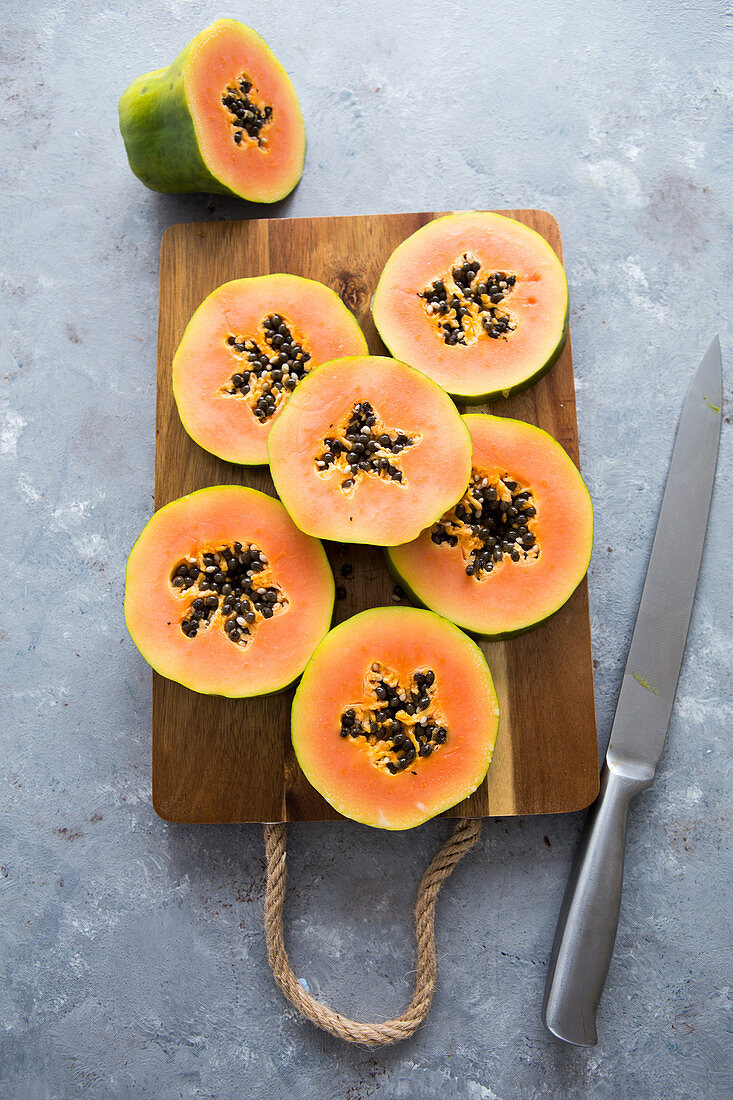 Papaya slices on a chop board
