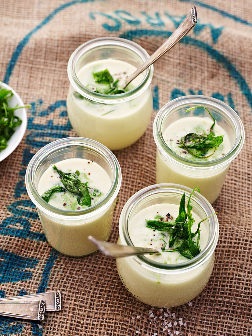 Potato soup with rocket served in glasses