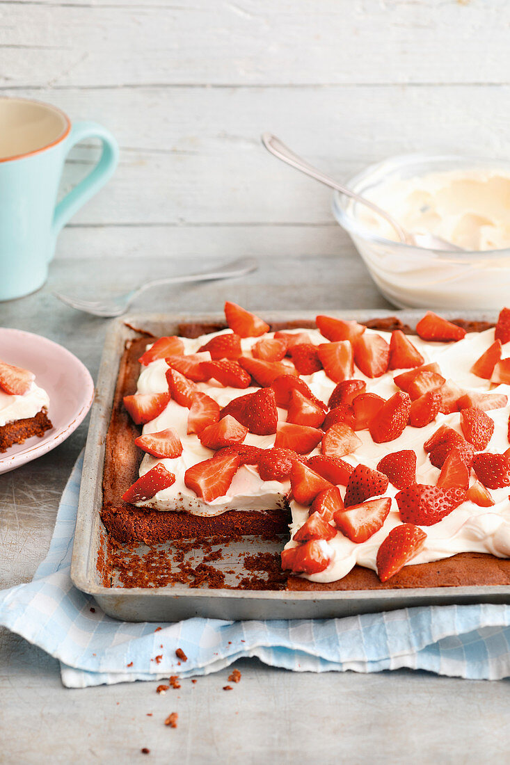 Quick chocolate strawberry cake with Greek yoghurt on a baking tray