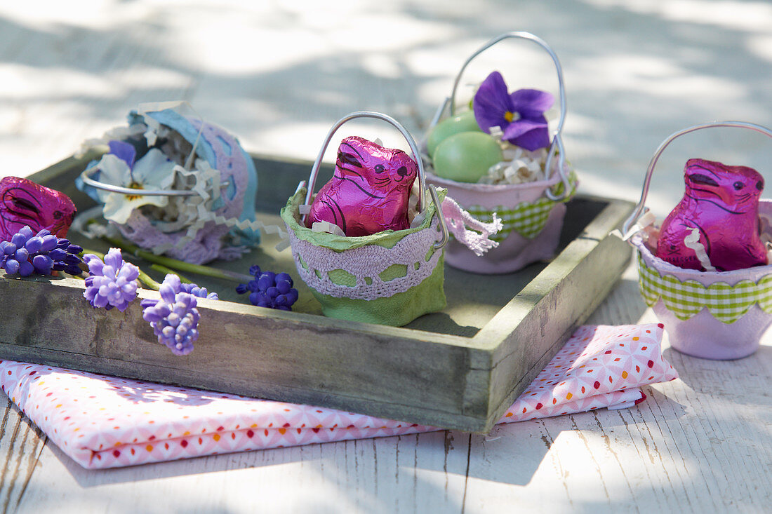 Chocolate bunnies in Easter nests hand-made from egg boxes