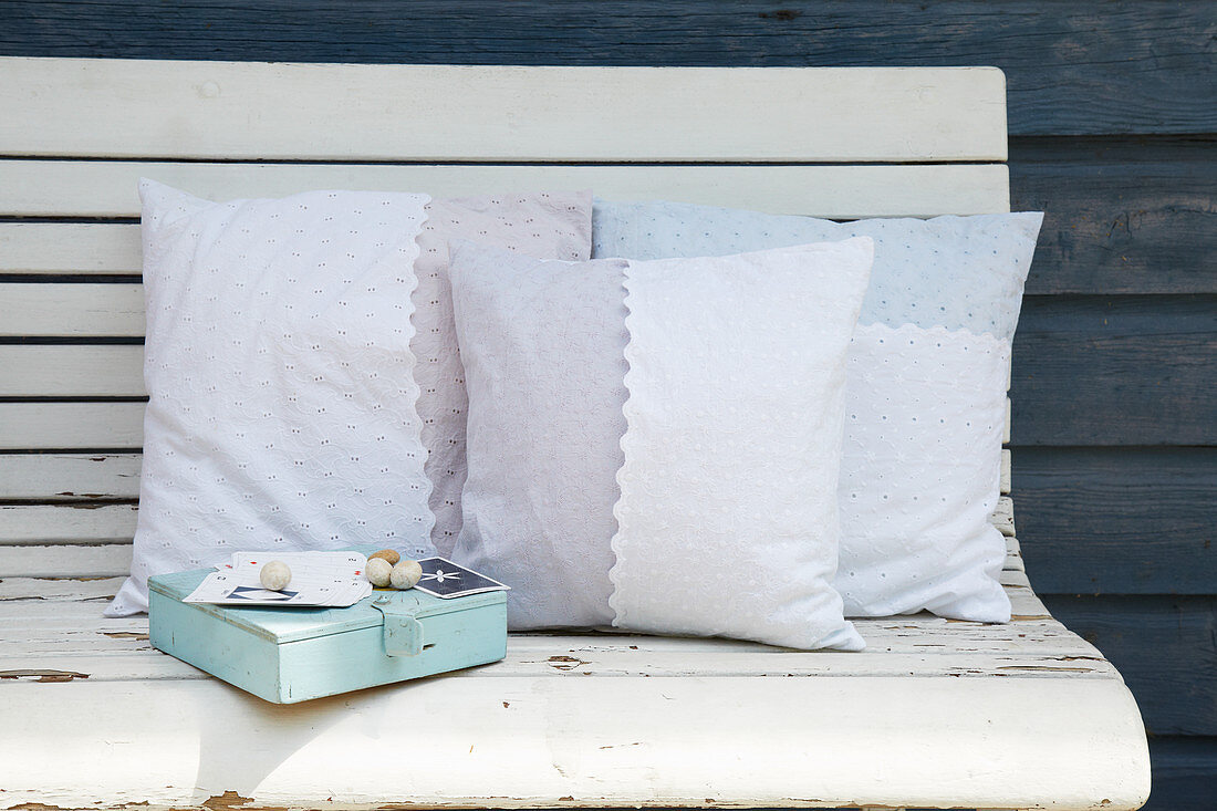 Cushion with hand-sewn cover on wooden bench