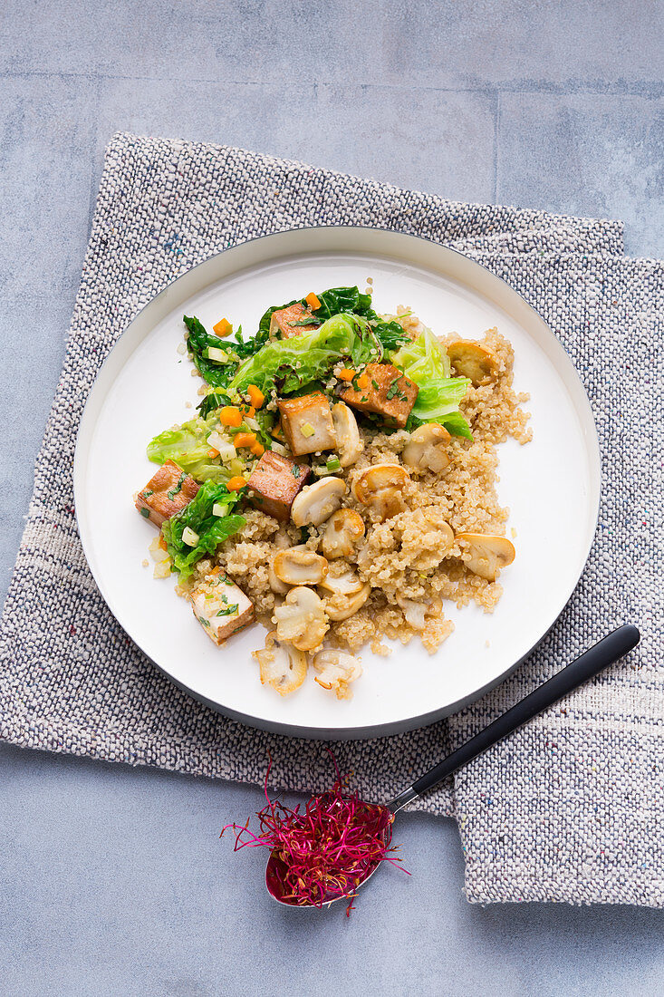 Savoy cabbage with fried smoked tofu on a bed of quinoa