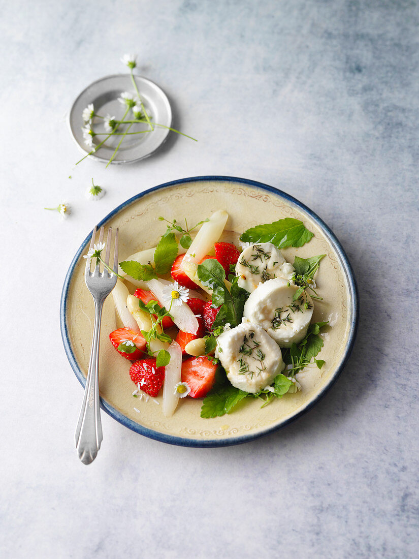 Goat's cheese on a wild herb and asparagus salad