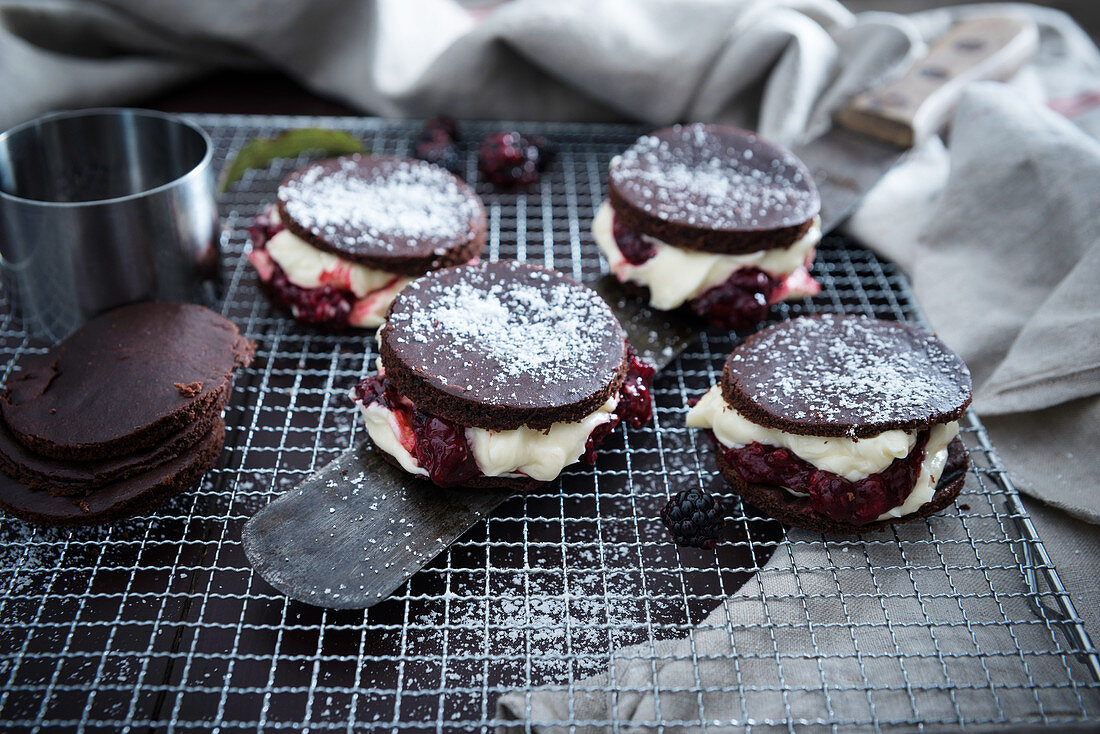Vegan chocolate cakes filled with vanilla cream and blackberry mousse