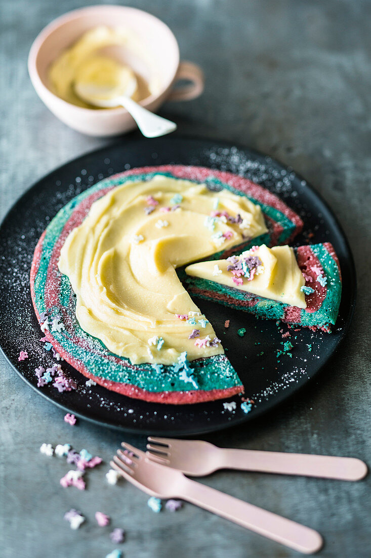 A colourful unicorn cake baked in a pan