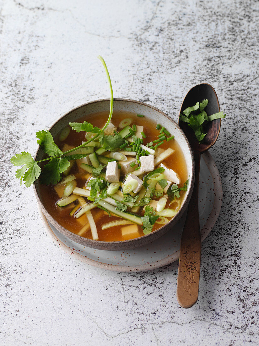 Vegan miso soup with tofu and herbs