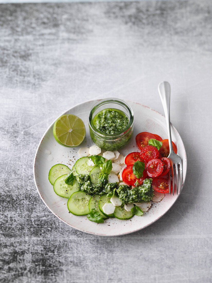 A plate of raw vegetables with basil and coconut pesto
