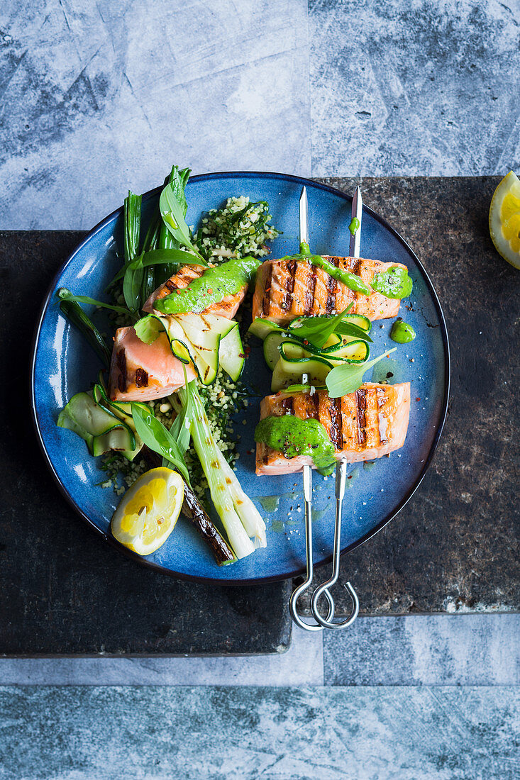 Salmon skewers with wild garlic, courgettes and spring onions