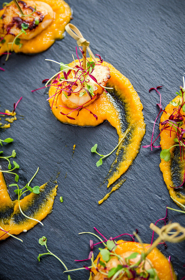 Fried scallops on mashed butternut squash with cress